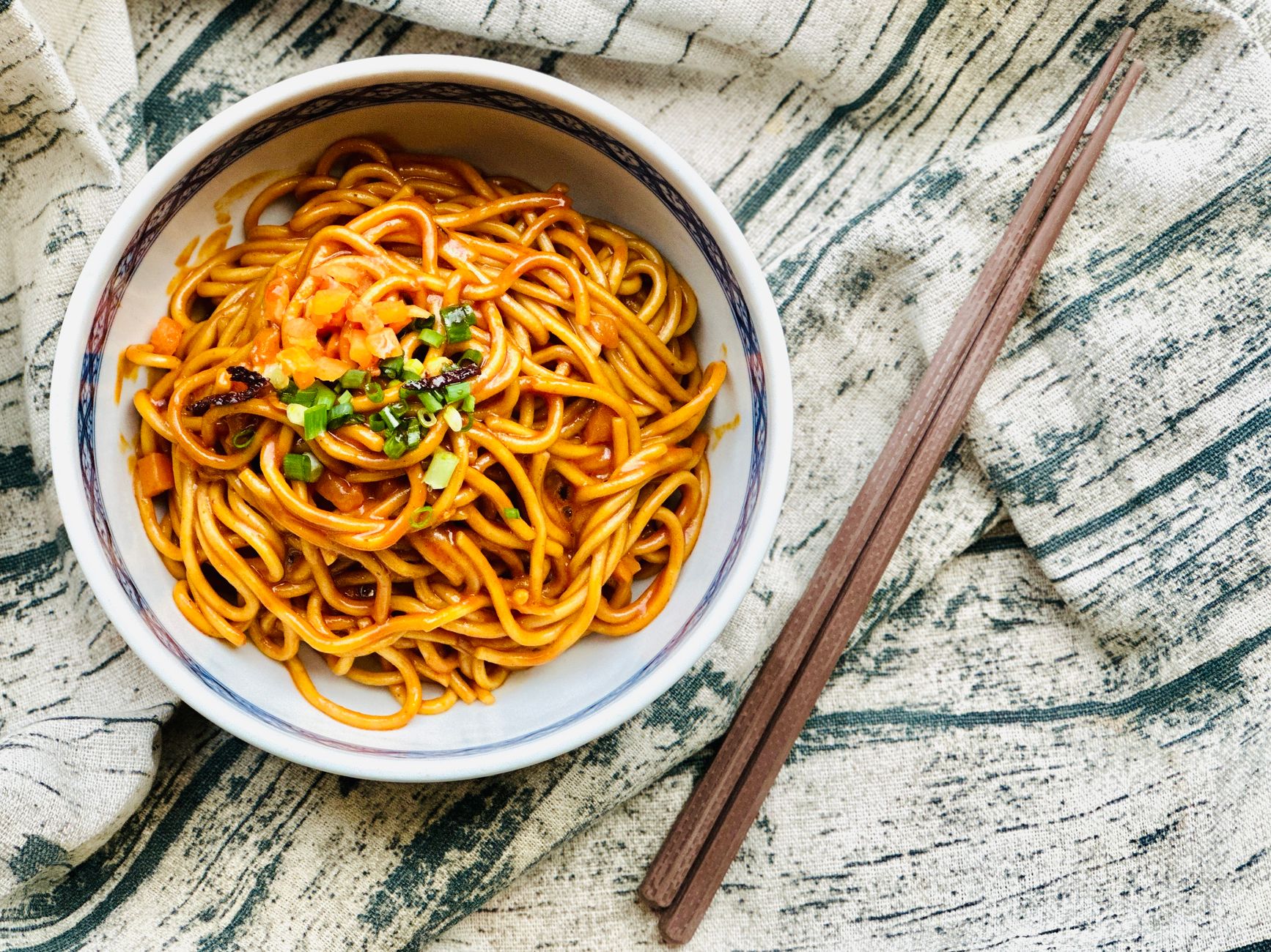 What is Cincinnati chili and why do they serve it over spaghetti noodles?