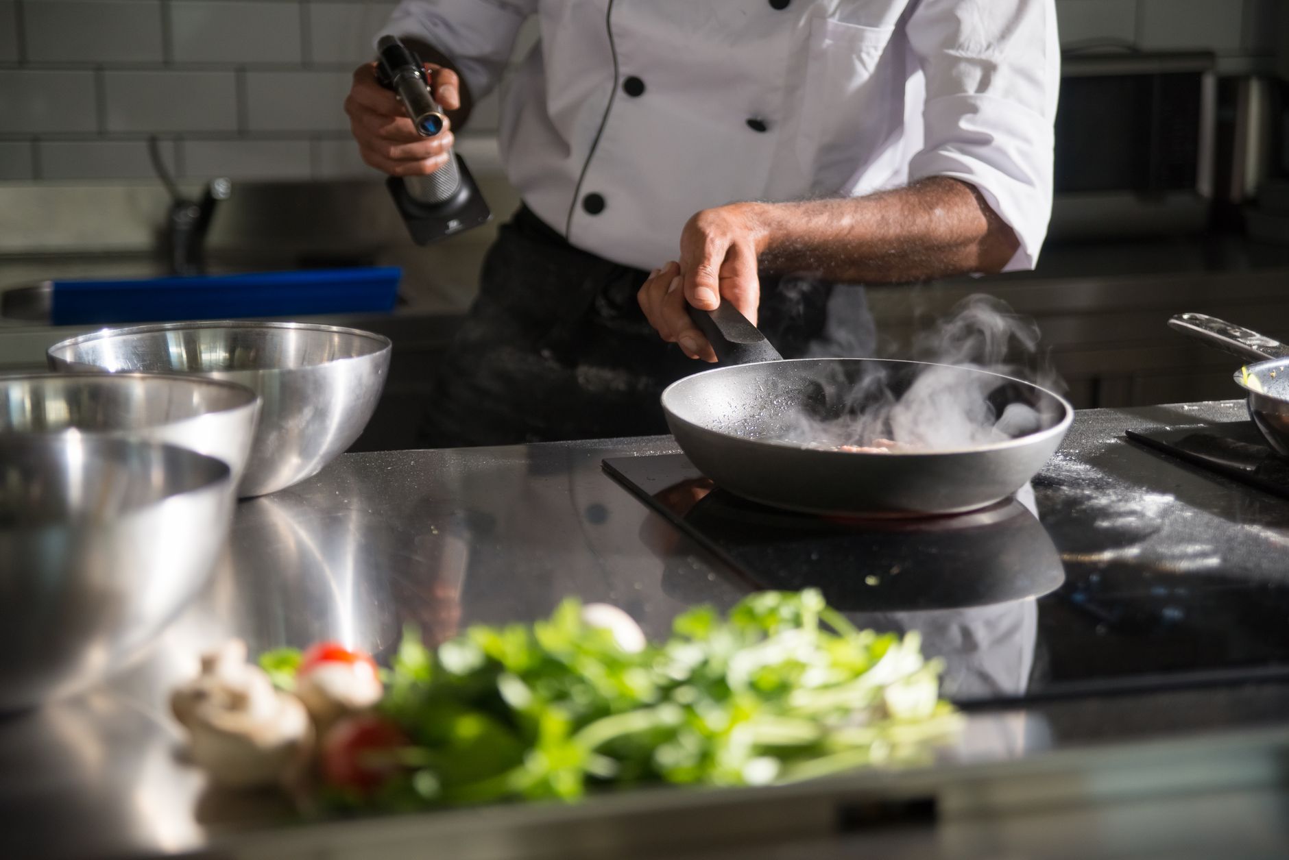 How do restaurant chefs manage to keep their stainless steel pans completely non-stick?